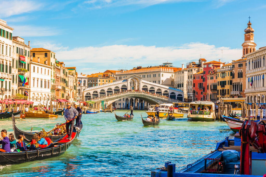 Panoramic view of the Grand Canal with gondolas and the Rialto Bridge. Venice, Italy.